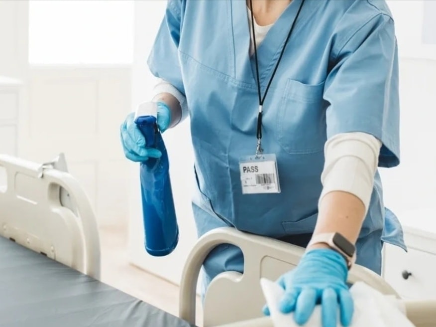 Healthcare cleaning professional in PPE